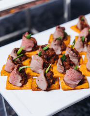 Catering table, beautifully decorated banquet with variety different food snacks appetizers on christmas corporate birthday party event or wedding celebration, canape, salad, delicatessen setting