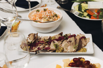 Catering table, beautifully decorated banquet with variety different food snacks appetizers on christmas corporate birthday party event or wedding celebration, canape, salad, delicatessen setting