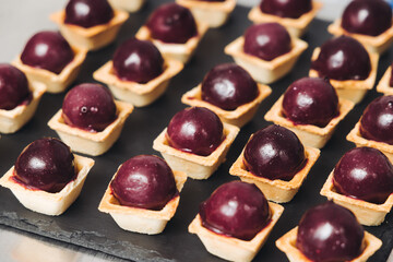 Catering table, beautifully decorated banquet with variety different food snacks appetizers on christmas corporate birthday party event or wedding celebration, canape, salad, delicatessen setting