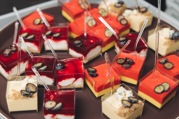 Catering table, beautifully decorated banquet with variety different food snacks appetizers on christmas corporate birthday party event or wedding celebration, canape, salad, delicatessen setting