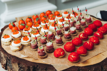 Catering table, beautifully decorated banquet with variety different food snacks appetizers on christmas corporate birthday party event or wedding celebration, canape, salad, delicatessen setting