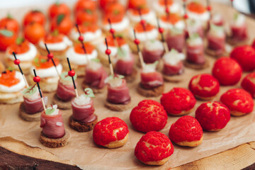 Catering table, beautifully decorated banquet with variety different food snacks appetizers on christmas corporate birthday party event or wedding celebration, canape, salad, delicatessen setting
