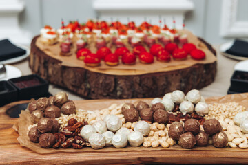 Catering table, beautifully decorated banquet with variety different food snacks appetizers on christmas corporate birthday party event or wedding celebration, canape, salad, delicatessen setting