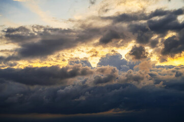 orange and blue background with cloudy sky with clouds at sunset in the evening