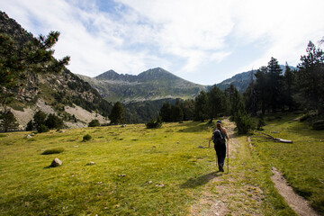 Young hiker woman in Vall de Boi, Aiguestortes and Sant Maurici National Park, Spain