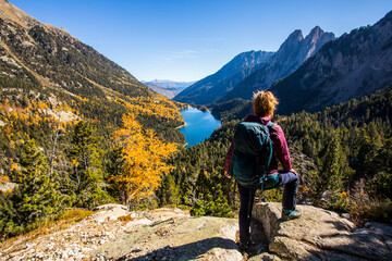 Young hiker woman in autumn in Aiguestortes and Sant Maurici National Park, Spain