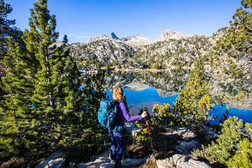 Young hiker woman in autumn in Aiguestortes and Sant Maurici National Park, Spain