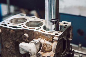 Engine cylinder boring on cnc machine. Boring under the piston after engine sleeve using machine with Computer Numerical Control.