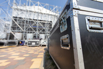 Boxes with concert equipment against a blurred stage. Preparing for a concert.