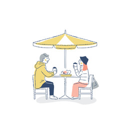 オープンカフェでくつろぐ冬服の若いカップル