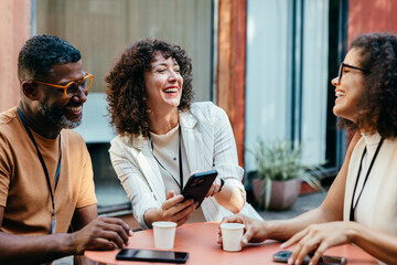 Coworkers from different backgrounds enjoying a cheerful coffee break together