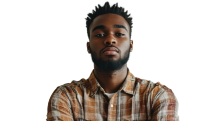 A confident young man with a serious expression poses with arms crossed. He has a stylish plaid shirt and a trendy hairstyle.