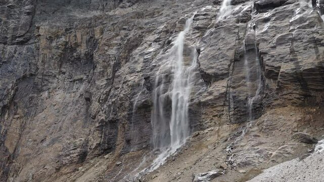 A rugged rocky mountain face with cascading waterfalls, Mount Edith Cavell, Canada