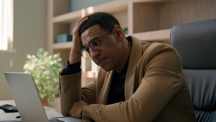Upset stressed African American man negative emotion fail business project with laptop desperate...