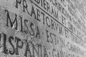 Black-and-white close-up of an ancient Roman inscription from The Deeds of the Divine Augustus...