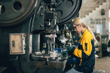 Caucasian women worker working in heavy metal industry factory punching stamping steel machine