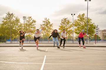 Group of rollerbladers racing outdoors on a sunny day