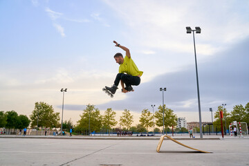 Skater performing a high jump over a ramp at sunset © Oscar