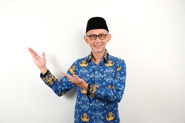 Government worker man wearing korpri batik pointing to the copy space. ASN civil servant 
