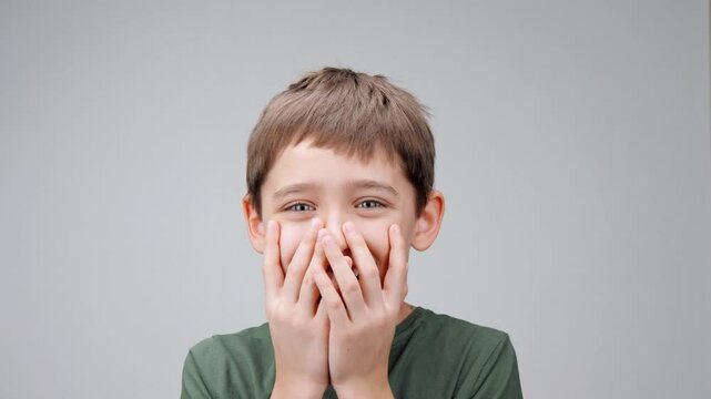 Smiling young boy. Portrait surprised boy with his mouth open. expresses delight and surprise at what he sees. child emotional reaction to something amazing. Close-up of boy delight