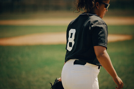 Baseball player in uniform with number 8 on jersey walking on the field