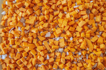Pumpkin cubes and onion in spices. texture of diced pumpkin with onions and spices for filling pumpkin pie. High quality photo