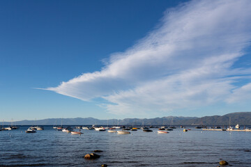 clouds and boats over lake