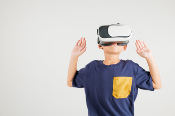 Portrait Asian smiling kid boy touching at something in a virtual reality glasses headset studio shot isolated white background, Excited happy primary child using VR play simulation game