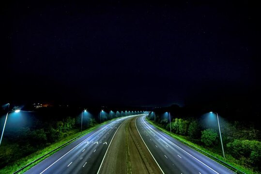 Nighttime Timelapse of M62 Motorway from Bridge with Moving Stars