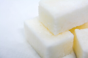 Refined sugar cubes on a white background. Close-up, macro. White sugar cubes.