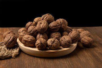 walnuts on a wooden plate side view
