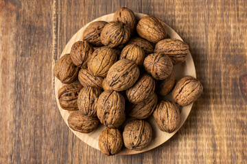 walnuts on a wooden plate top view