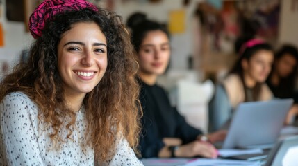 Smiling young woman with curly hair among colleagues in a creative office setting