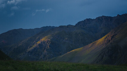 sun raus penetrate the grey clouds over the Caucasus Mountains
