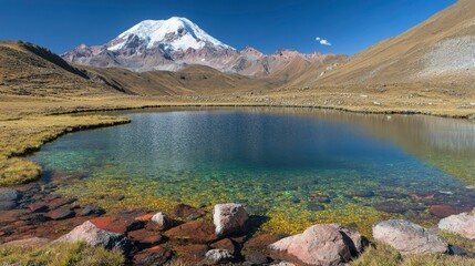 Fototapeta premium Crystal Clear Alpine Lake Reflects Majestic Snowcapped Mountain