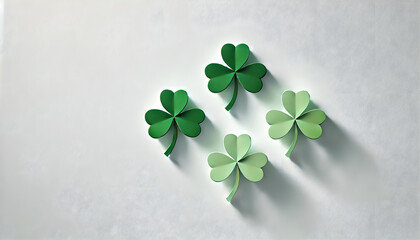 Three simple shamrocks in different sizes, arranged diagonally with ample white space for copy.