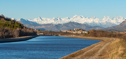 Le Poët village and snow-covered mountains of Ecrins National Park (Chaillol peak at center) with...