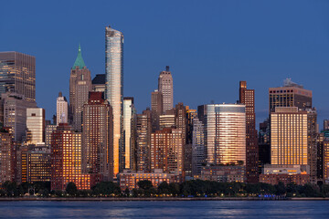 Fototapeta premium Battery Park and Lower Manhattan skyscrapers in New York City at twilight. Cityscape from the Hudson River