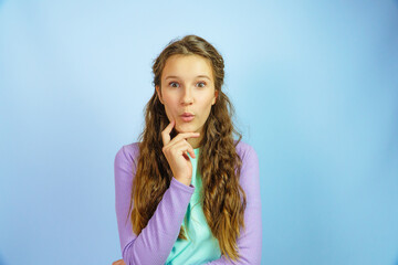 Fototapeta premium Surprised young girl on yellow background