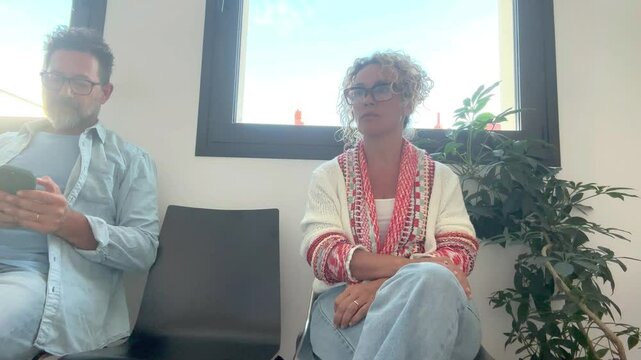 A couple of fifty years old, seated in a lawyer's office, anxiously waits for the finalization of their divorce paperwork, reflecting on their decision to separate after a long relationship and years 