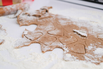 woman making heart shaped cookies in the kitchen