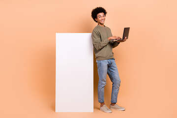 Full body photo of young man it coder hold netbook development new application smartphone display...