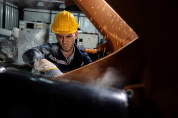 Fototapeta premium Mechanic Repairing a Robotic Arm in Factory