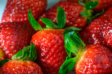 Fresh strawberries glistening under gentle light in a vibrant summer setting