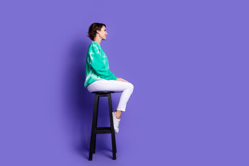 Full size photo of attractive young woman profile sit chair dressed stylish green clothes isolated...