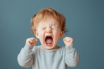 A baby yelling in distress, with tears streaming down their face and their tiny hands clenched into fists