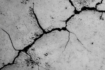 Fototapeta premium Detailed texture of cracked concrete surface highlighting unique patterns and aging signs