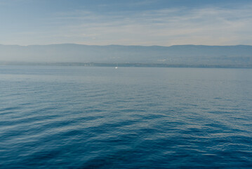 view of the mountains from the lake in foggy weather