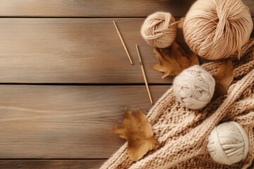 A knitting-themed flat lay featuring yarn balls, needles, and a finished scarf arranged artistically on a rustic wooden table