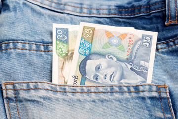 Old Myanmar kyat in the pocket of blue jeans